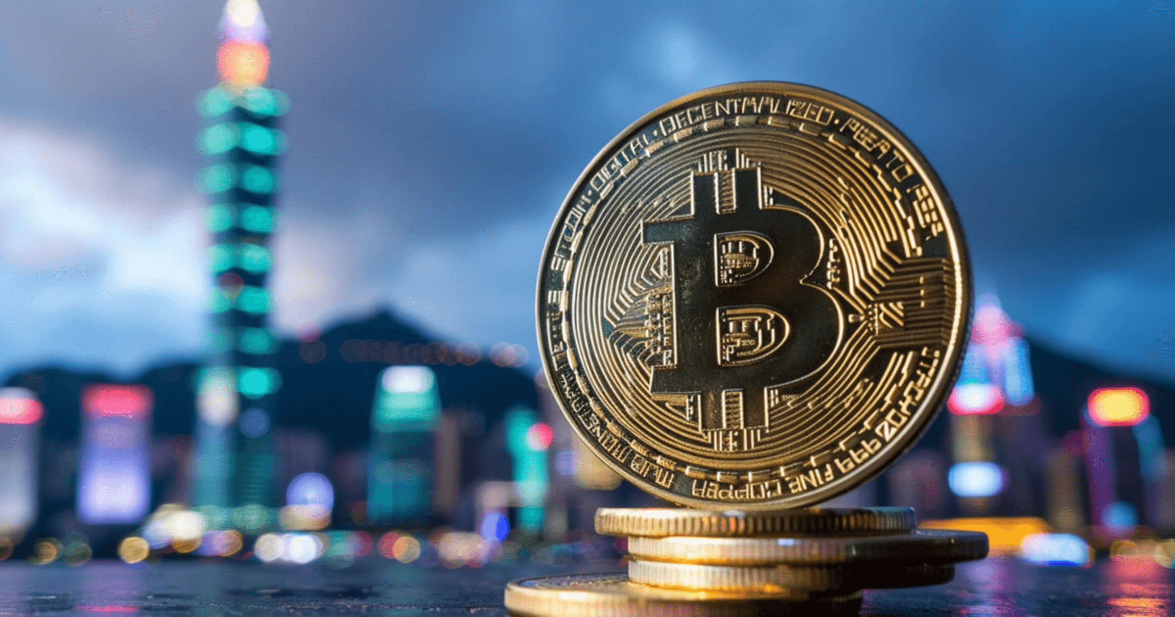A close-up of a gold Bitcoin coin placed on a smartphone displaying a stock market chart.